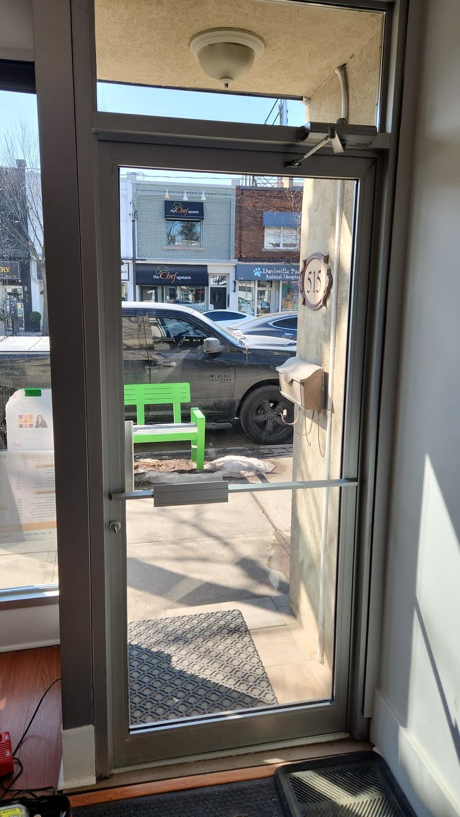 Fully restored commercial door with new tempered glass installed by LuminaSky Glass
