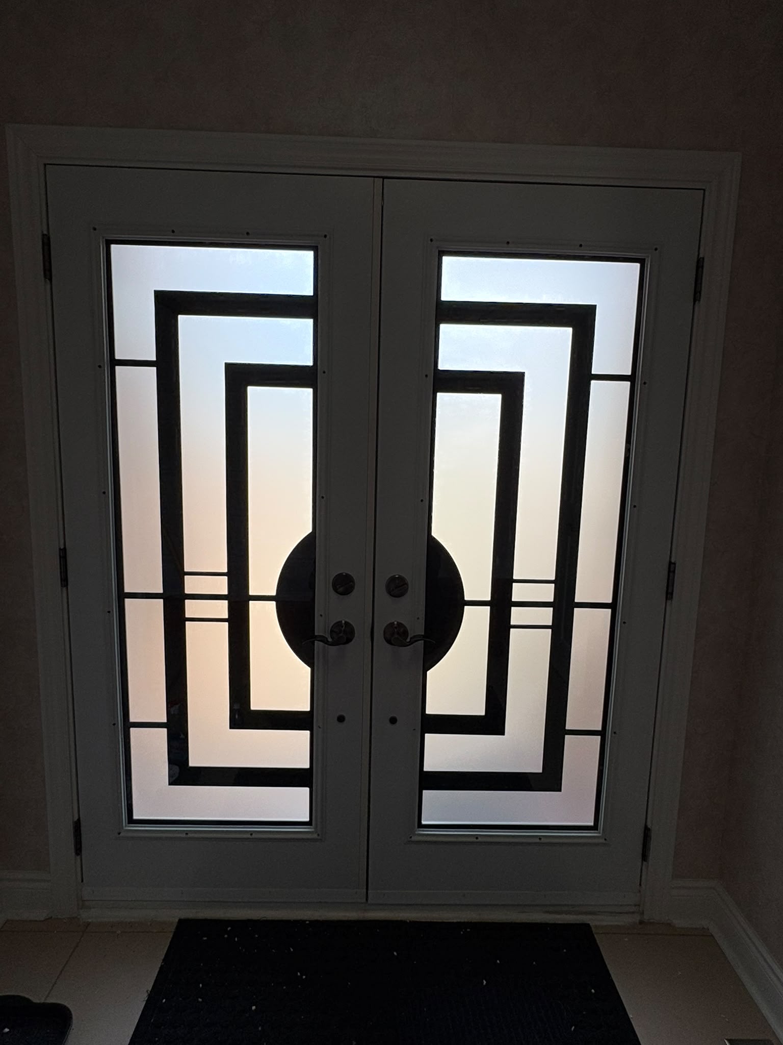 Same front doors after upgrade to modern geometric iron glass inserts with frosted privacy glass