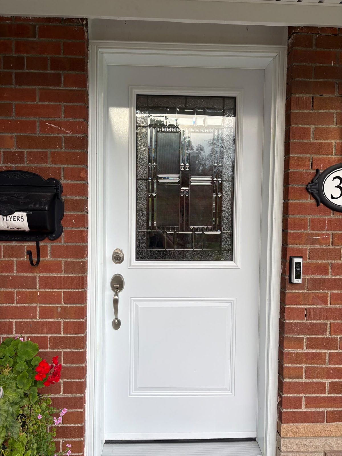 New modern white front door with large decorative leaded glass insert after LuminaSky replacement in Scarborough