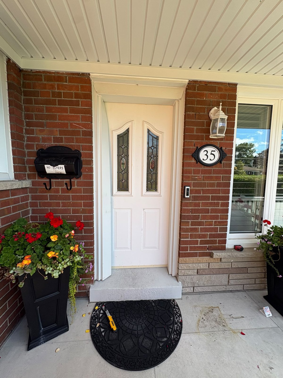 Dated cream double front doors with small decorative glass panels before replacement in Scarborough