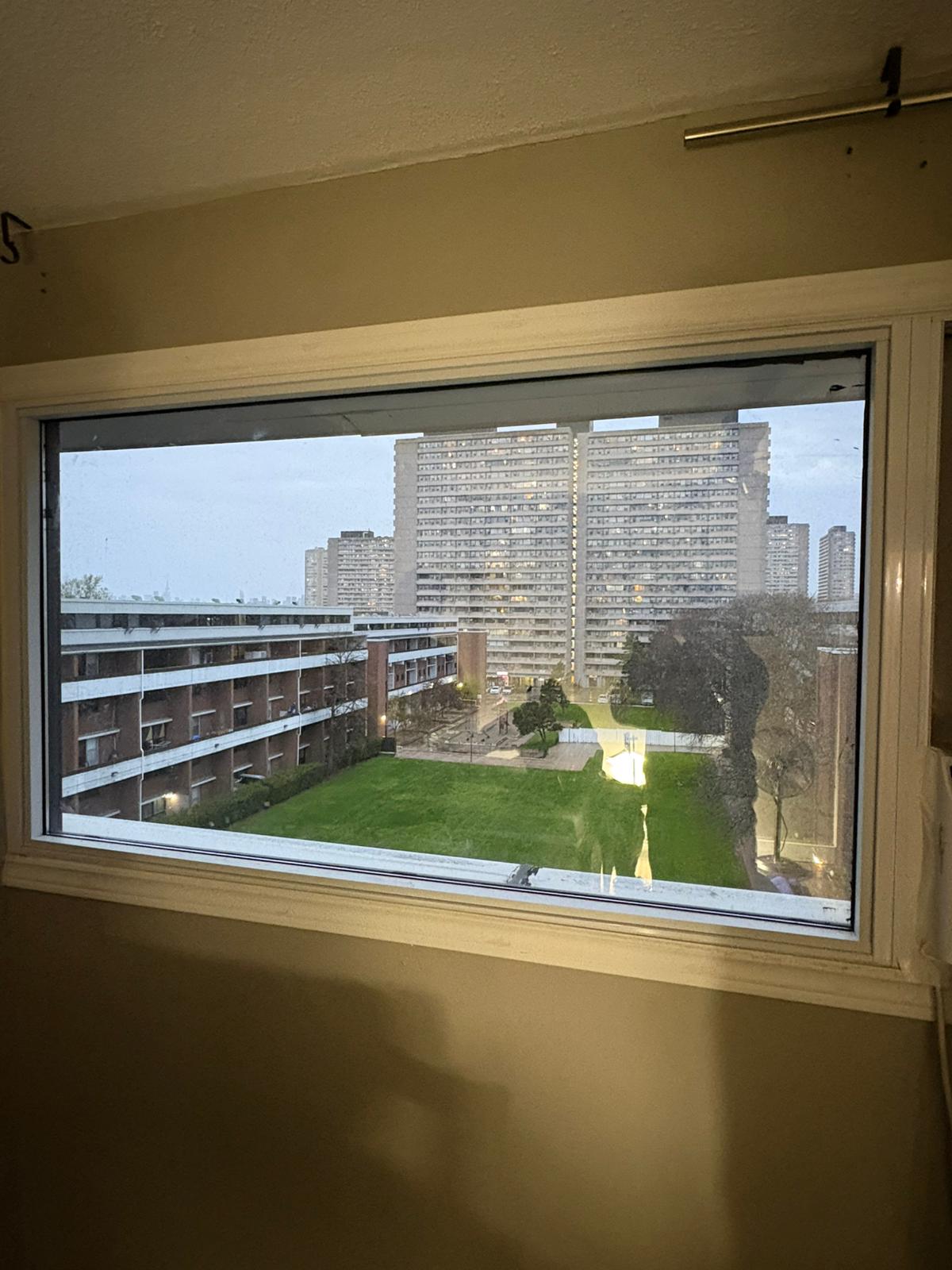 Spotless high-rise window with a crystal-clear view of the city skyline